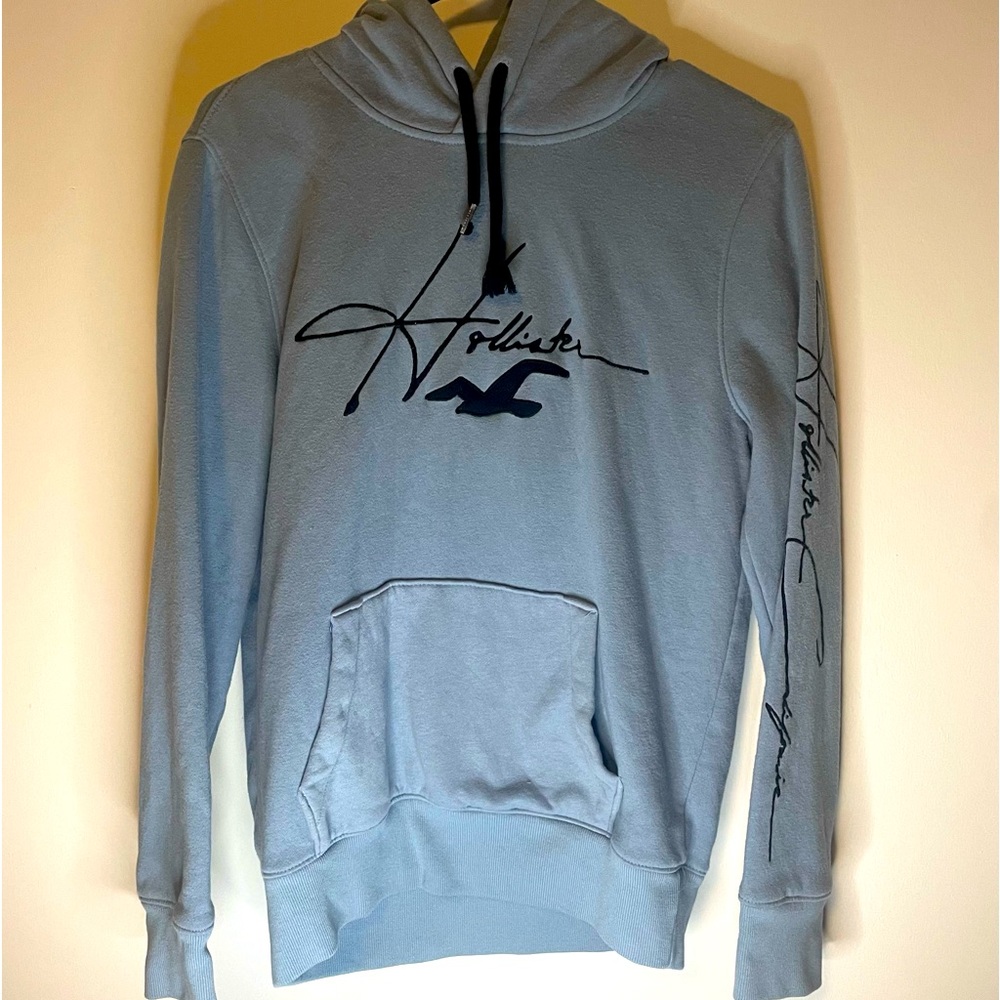 Hollister Light Blue Hoodie Mens Size XS. Black Logo Detail on Left Sleeve